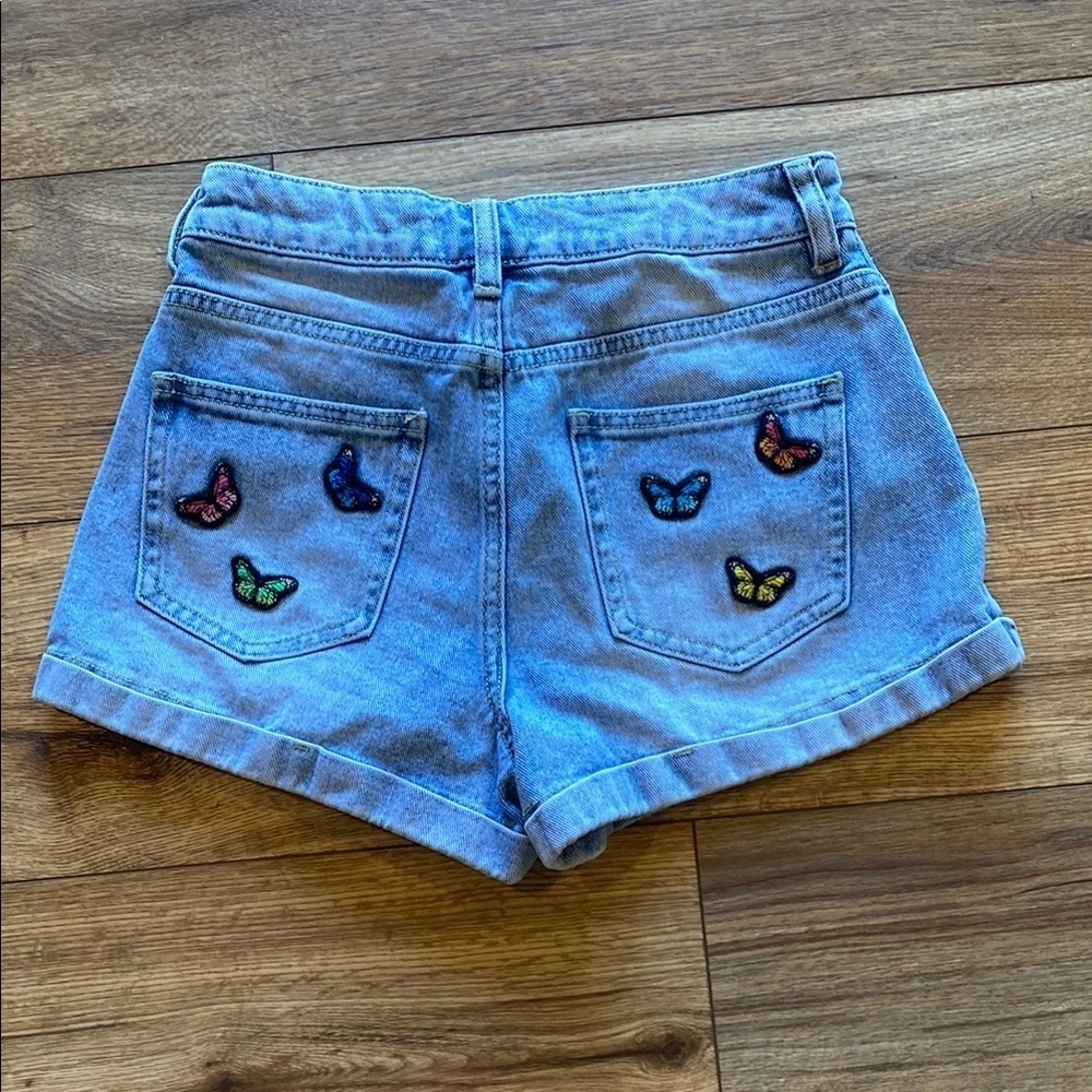 light-wash Mom shorts from PacSun with butterfly patches on back pockets